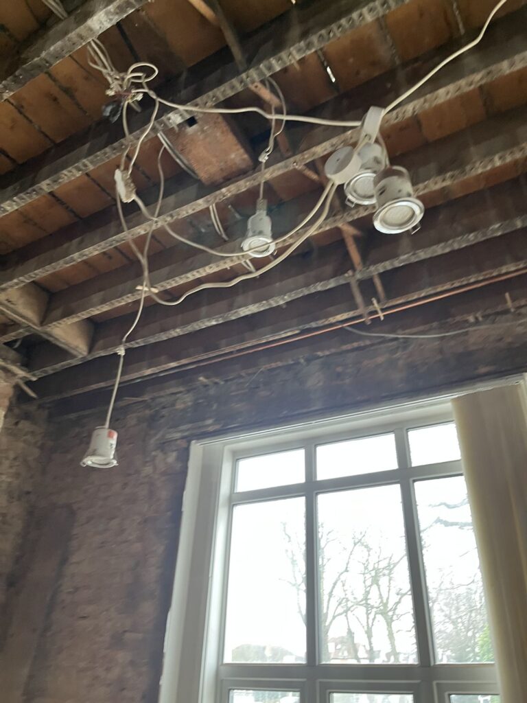 Exposed floor joists and brickwork at 267 Ballards Lane during the residential-to-office conversion